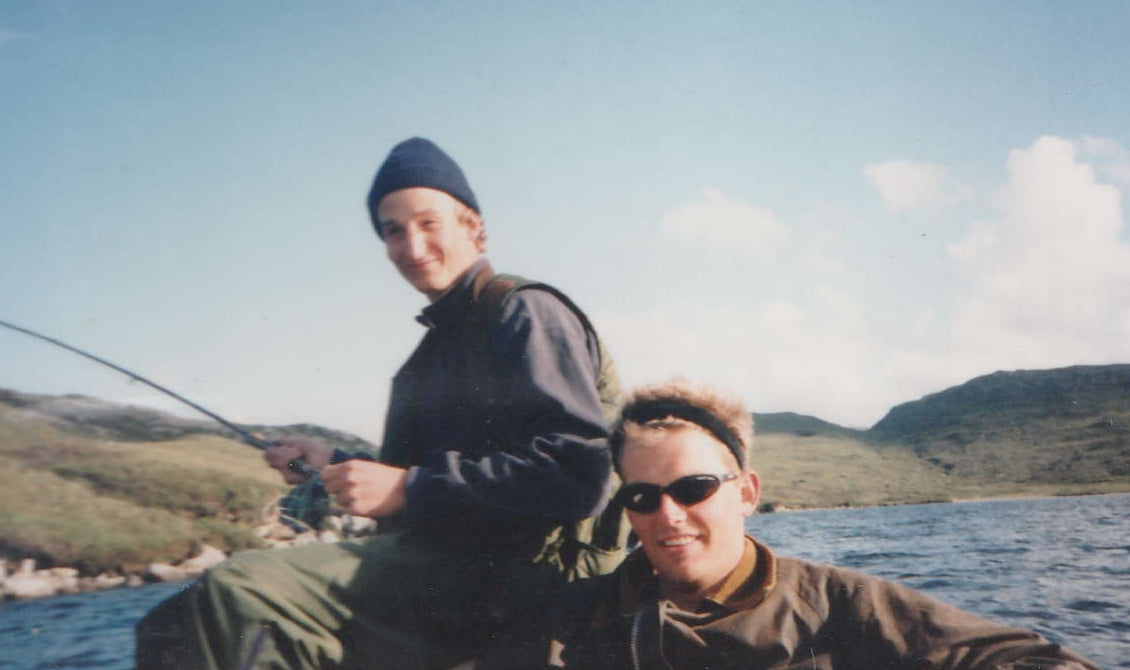 Harry, the eldest Green brother, fishing from the boat on the loch in Uig