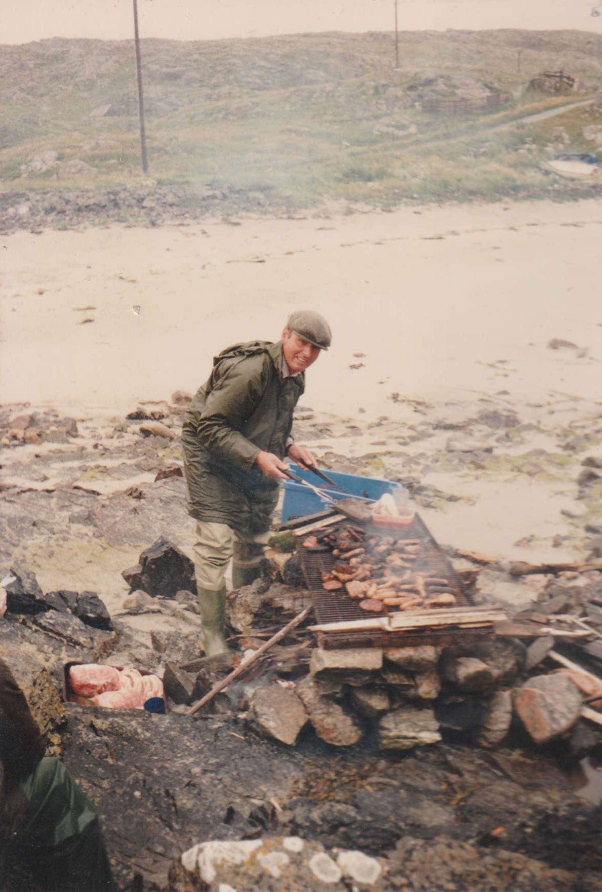Old photograph of Malcolm Green preparing a barbecue in Uig
