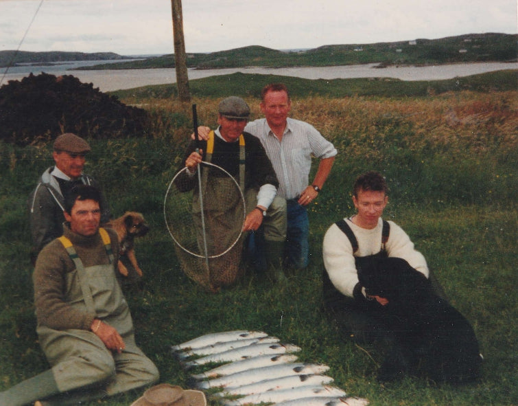 Old photography of Uig Lodge, men sitting with a great catch of salmon