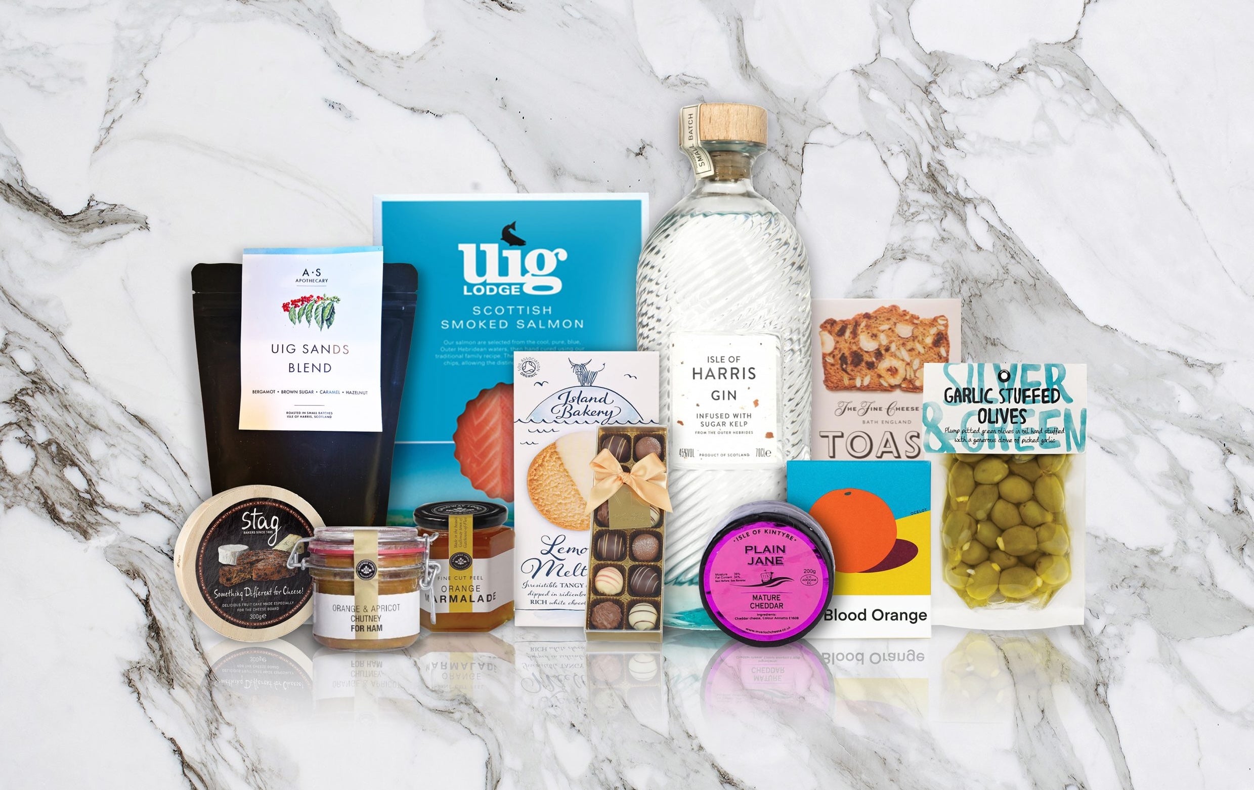 Collection of Scottish food and drink products on a marble surface