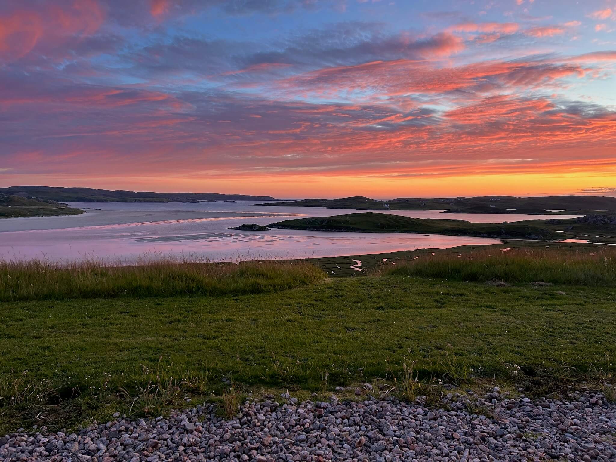 Stunning sunset view over Uig Bay as seen from Uig Lodge Private Lettings, showcasing the breathtaking natural beauty of the Isle of Lewis.