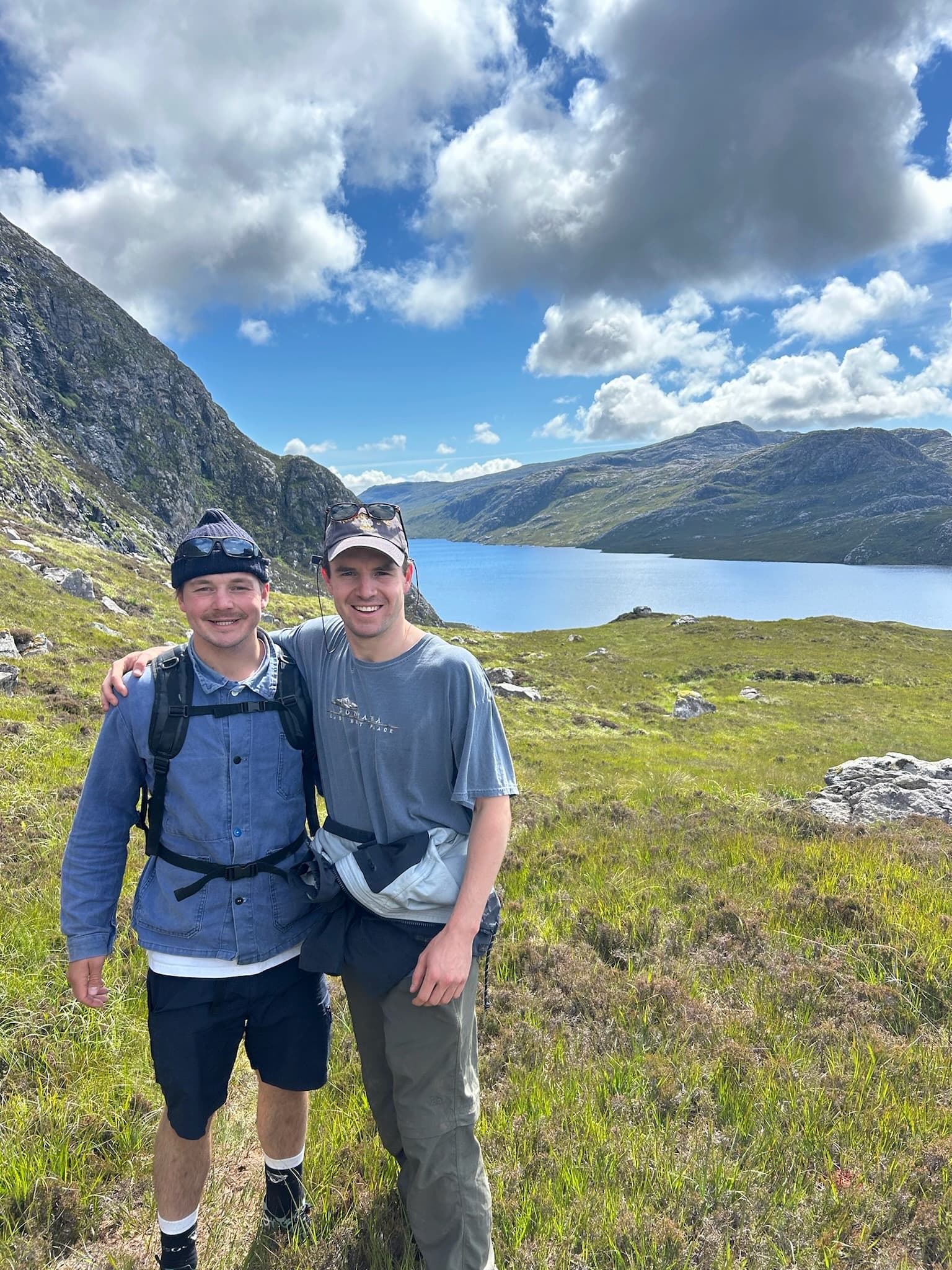 Smiling boys in front of a mountain at Uig Lodge, with breathtaking views of Scottish lochs in the background